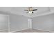 Bedroom features a tray ceiling with ceiling fan, neutral paint, and carpet flooring at 13258 Sw 29Th Cir, Ocala, FL 34473
