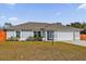 Single-story home featuring an attached two-car garage and manicured landscaping at 13258 Sw 29Th Cir, Ocala, FL 34473