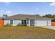 Charming single-story home featuring a two-car garage, simple landscaping, and a well-manicured lawn at 13258 Sw 29Th Cir, Ocala, FL 34473