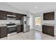 A well lit kitchen featuring stainless steel appliances and dark cabinets at 13258 Sw 29Th Cir, Ocala, FL 34473