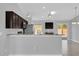 Modern kitchen with stainless steel appliances, dark wood cabinets, and granite countertops at 13258 Sw 29Th Cir, Ocala, FL 34473