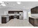 Bright kitchen featuring stainless steel appliances, granite countertops, and dark cabinets at 13258 Sw 29Th Cir, Ocala, FL 34473