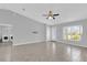 Spacious and bright living room features neutral walls and tile flooring with laundry in the background at 13258 Sw 29Th Cir, Ocala, FL 34473