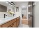 Bathroom featuring a double vanity with wood cabinets and black hardware at 13631 Guildhall Cir, Orlando, FL 32828