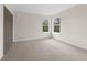 Bright bedroom with two windows, neutral carpet and closet at 13631 Guildhall Cir, Orlando, FL 32828