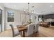 Bright dining room features wood floors, stylish lighting, and lots of natural light at 13631 Guildhall Cir, Orlando, FL 32828