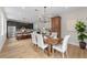 Bright dining room features wood floors, stylish lighting, and direct access to the kitchen at 13631 Guildhall Cir, Orlando, FL 32828