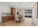 Lovely dining room features wood floors, stylish lighting, and lots of natural light at 13631 Guildhall Cir, Orlando, FL 32828