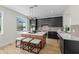 Modern kitchen featuring an island, stainless steel appliances, black cabinetry and contemporary pendant lighting at 13631 Guildhall Cir, Orlando, FL 32828