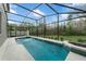 Gorgeous pool with a screened in lanai surrounded by lush landscaping and mature trees at 13631 Guildhall Cir, Orlando, FL 32828