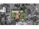 An aerial view shows the house on a lush green lot surrounded by a black and white neighborhood at 14 E Cypress St, Davenport, FL 33837