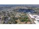 An aerial view shows a neighborhood with houses and mature trees in an overview perspective at 14 E Cypress St, Davenport, FL 33837