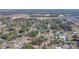 An aerial view captures a wide perspective of a neighborhood with houses and trees at 14 E Cypress St, Davenport, FL 33837