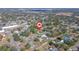 An aerial view shows a neighborhood with mature trees and houses with the subject property marked by a red pin at 14 E Cypress St, Davenport, FL 33837