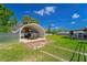 Backyard showcasing a metal storage building with a truck parked inside and lush green grass at 14 E Cypress St, Davenport, FL 33837