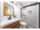 Modern bathroom featuring a sleek vanity and a marble-tiled shower with glass enclosure at 14 E Cypress St, Davenport, FL 33837