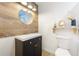 Modern bathroom featuring a wood accent wall, sleek vanity, and updated fixtures and decor at 14 E Cypress St, Davenport, FL 33837