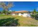 Charming single-story home with a red tile roof and lush front yard at 14 E Cypress St, Davenport, FL 33837