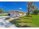 Charming home with a red tile roof, American flag, and attached garage at 14 E Cypress St, Davenport, FL 33837