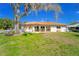 Charming single-story home with a tile roof and well-maintained lawn at 14 E Cypress St, Davenport, FL 33837