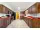 Spacious kitchen featuring modern appliances, wooden cabinets, and orange countertops at 14 E Cypress St, Davenport, FL 33837