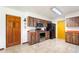 Kitchen featuring stainless steel appliances, wood cabinets, and tile flooring at 14 E Cypress St, Davenport, FL 33837