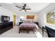 Comfortable main bedroom with a ceiling fan, tile floors, and lots of bright, natural light at 14 E Cypress St, Davenport, FL 33837