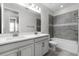 Bathroom featuring double vanity, tiled shower and soaking tub at 14101 Creekbed Cir, Winter Garden, FL 34787