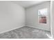 Cozy bedroom with carpet, neutral paint, and a window overlooking the yard at 14101 Creekbed Cir, Winter Garden, FL 34787