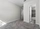 Bedroom with neutral carpet and paint, adjacent to the ensuite bathroom at 14101 Creekbed Cir, Winter Garden, FL 34787