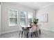 Bright dining area with large windows, modern art, and sleek furniture at 14101 Creekbed Cir, Winter Garden, FL 34787