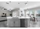 Kitchen island featuring a sink, dishwasher, quartz countertop and pendant lighting at 14101 Creekbed Cir, Winter Garden, FL 34787