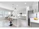 Modern kitchen with white cabinetry, quartz countertops, stainless steel appliances, and breakfast bar at 14101 Creekbed Cir, Winter Garden, FL 34787