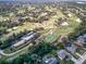 Aerial view of homes located next to fairways and golf course greens at 1433 Ne Old Mill Dr, Deltona, FL 32725