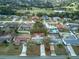 Aerial view of home with mature landscaping, a golf course, and neighborhood streets at 1433 Ne Old Mill Dr, Deltona, FL 32725