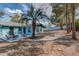 View of backyard with a patio seating area, palm tree, and privacy fence at 1433 Ne Old Mill Dr, Deltona, FL 32725