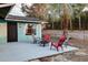 Backyard featuring a patio with chairs and a fire pit, with mature landscaping at 1433 Ne Old Mill Dr, Deltona, FL 32725