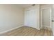 Neutral bedroom featuring a closet with bifold doors and wood-look flooring at 1433 Ne Old Mill Dr, Deltona, FL 32725