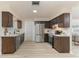 Spacious kitchen with stainless steel appliances, quartz countertops, and dark wood cabinetry at 1433 Ne Old Mill Dr, Deltona, FL 32725