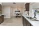 Open-concept kitchen with stainless steel sink, and a view into the dining area at 1433 Ne Old Mill Dr, Deltona, FL 32725