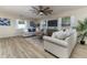 Inviting living room with two sofas, a ceiling fan, and a view of the outdoors at 1433 Ne Old Mill Dr, Deltona, FL 32725