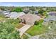 Aerial view of the home showing the well-manicured lawn, mature trees, and a paved driveway at 14851 Oldham Dr, Orlando, FL 32826