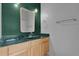 Bathroom with a light wood vanity, a light-colored countertop, and a large mirror at 14851 Oldham Dr, Orlando, FL 32826