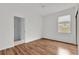 Bright bedroom with wood-look flooring, a ceiling fan, and a window providing natural light at 14851 Oldham Dr, Orlando, FL 32826