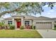 Charming single-story home with a well-maintained lawn and mature landscaping at 14851 Oldham Dr, Orlando, FL 32826