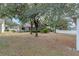 View of the backyard and the back of the house and screened-in porch at 15318 Harvest Blvd, Clermont, FL 34714