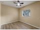 Bright bedroom with wood floors, neutral walls, ceiling fan, and natural light at 15318 Harvest Blvd, Clermont, FL 34714