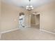 Dining room leading to the kitchen, featuring tile flooring, neutral paint and a chandelier at 15318 Harvest Blvd, Clermont, FL 34714