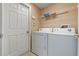 The laundry room features a full-sized washer and dryer, and a wire shelf at 15318 Harvest Blvd, Clermont, FL 34714