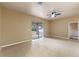 Bright living room with ceiling fan, tile flooring, neutral paint, and sliding glass doors to the patio at 15318 Harvest Blvd, Clermont, FL 34714